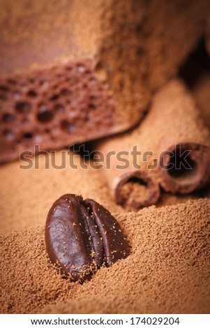 Coffee bean closeup in the ground coffee on a background of chocolate. macro texture. vertical