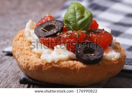 Fragrant Bruschetta with tomatoes, cheese and olives on the table.
