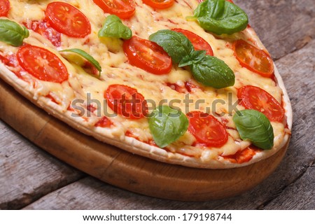 Neapolitan pizza margarita on the old wooden table closeup