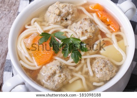 Meatball soup, noodles with vegetables on the table close-up. view from above.