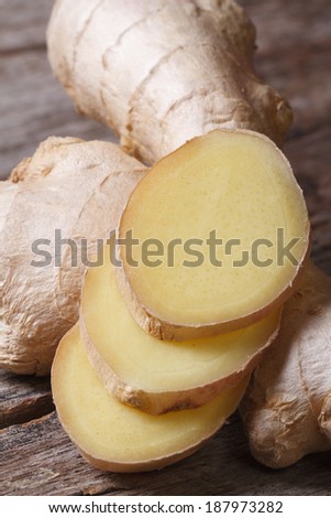 Sliced ginger root macro on a wooden table. vertical