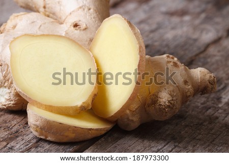 Macro pieces of of ginger root on the old table. horizontal
