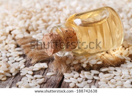 sesame seed oil in glass bottle on the table closeup horizontal