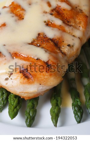 roasted meat with sauce Hollandaise and asparagus macro. view from above. vertical