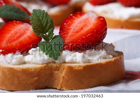 sandwich with strawberries, cheese and mint macro on the table. horizontal