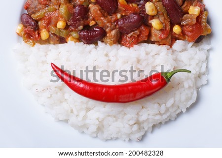 Time for lunch: chili con carne and rice village background horizontal top view