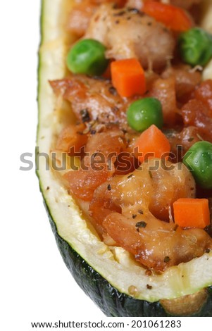 Zucchini stuffed with meat and green peas, carrot macro isolated on white background. vertical view from above
