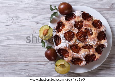 delicious plum cake close-up on a table top view horizontal