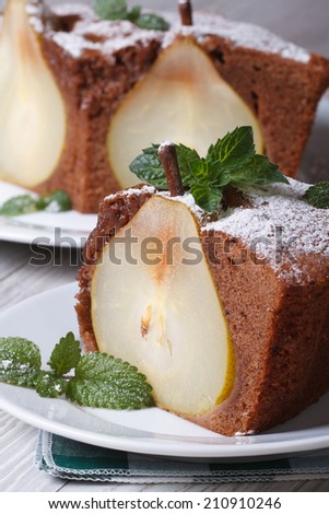 slice of pear pie with mint close up on a background of a cake vertical