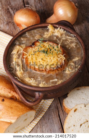 French onion soup with croutons and cheese close-up and ingredients. vertical