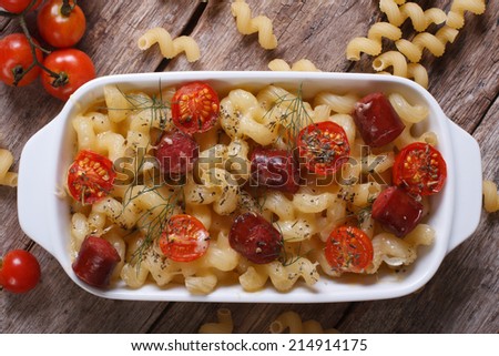 pasta baked with cherry tomatoes and sausages close-up view from above. horizontal
