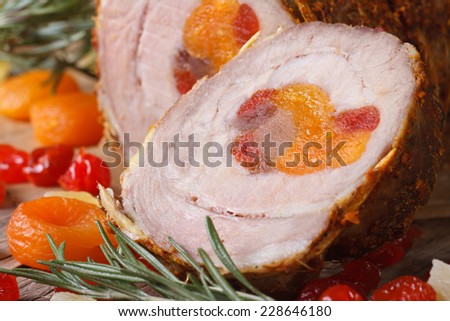 Roll meat with dried apricots, cherries and pineapple closeup. horizontal