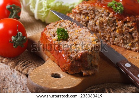 meat loaf with vegetables close-up on a cutting board. horizontal