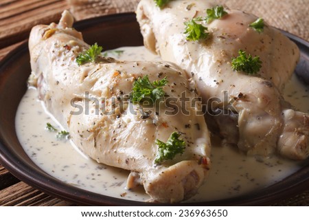 Dietary rabbit meat in cream sauce closeup on a plate on the table. horizontal