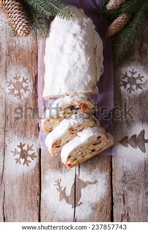 German slices Stollen Christmas cake on the table with decoration. vertical top view