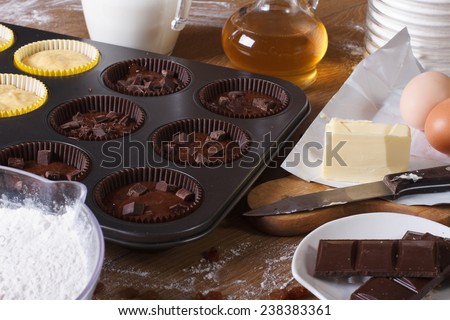 cooking chocolate and vanilla cupcakes close-up on the table. horizontal