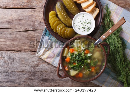 Polish soup made from sour cucumbers on the table. horizontal view from above