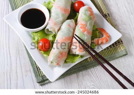Korean spring rolls with shrimp and sauce on a plate close-up. horizontal