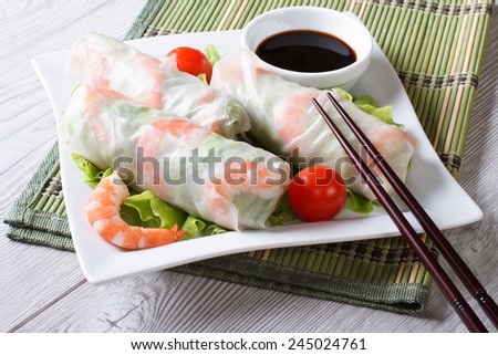 spring roll with shrimp and sauce on a plate close-up. horizontal
