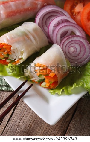 Vietnamese vegetable spring rolls with sauce on a plate close-up. vertical top view
