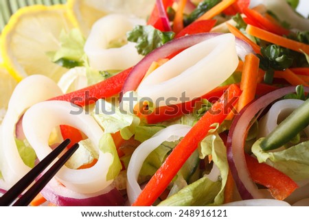 Japanese salad with vegetables and squid rings macro. horizontal
