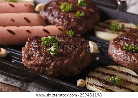 grilled burgers with vegetables in a pan grill closeup. horizontal