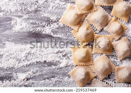 Italian uncooked ravioli with flour on the table. horizontal view from above