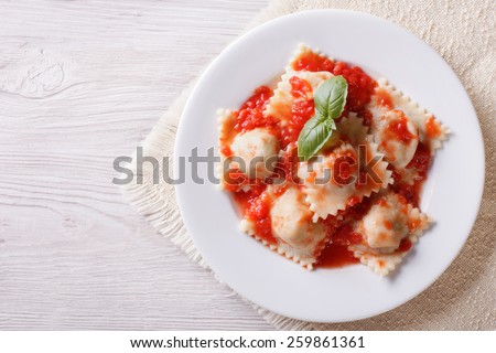 Ravioli with tomato sauce on a plate. horizontal view from above