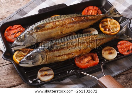 Grilled sea fish and vegetables in a pan grill closeup. horizontal