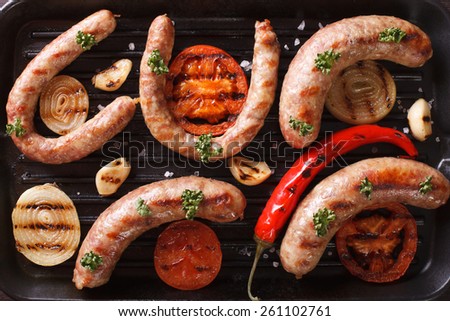 sausages and grilled vegetables on the grill close up. horizontal view from above