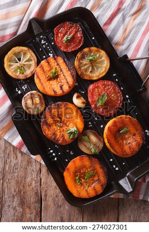 Grilled pumpkin and vegetables on the grill pan closeup. vertical view above, rustic style