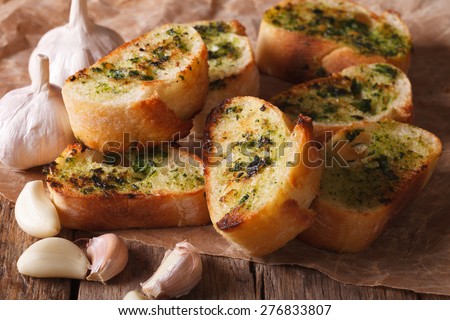 French toast with fresh herbs and garlic closeup on the table. Horizontal rustic style