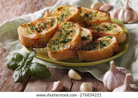 Toasts with basil and garlic close-up on a plate. horizontal, rustic style