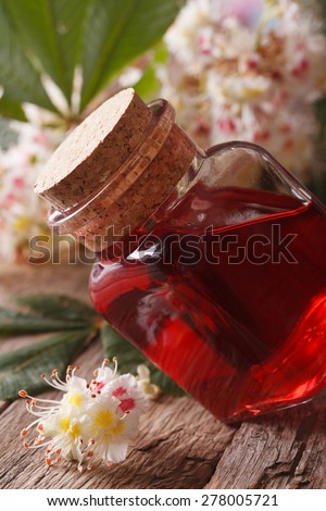 Medicine chestnut flower in a bottle on the table. macro vertical