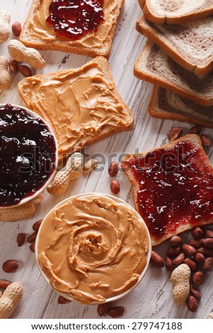 Sandwiches with peanut butter and jelly on the table. vertical
