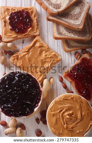 Toast with peanut butter and jam closeup on the table. vertical top view