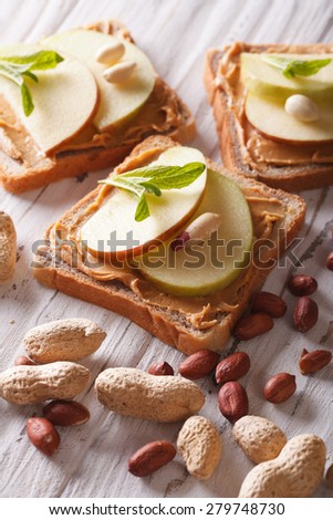 sweet toast with fresh apple and peanut butter on the table. vertical