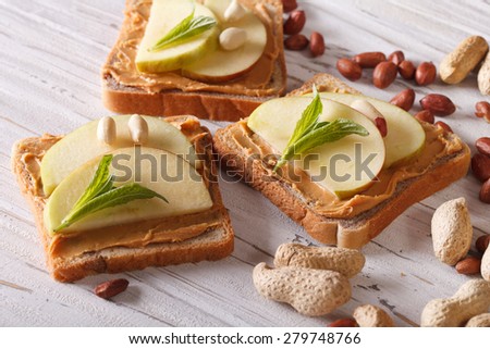 sweet toast with fresh apple and peanut butter on the table. Horizontal