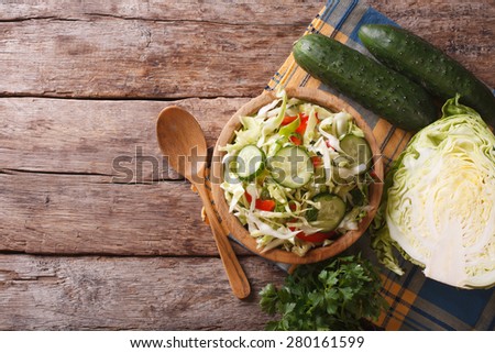 Homemade food: cabbage salad and ingredients on the table, view from above