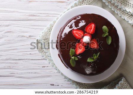 Chocolate cake with fresh strawberries on a table. horizontal view from above