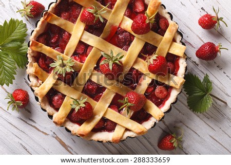 Strawberry cake with fresh berries close up in baking dish. horizontal view from above