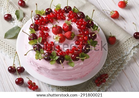 big pink cake with fresh berries on a plate close-up. horizontal