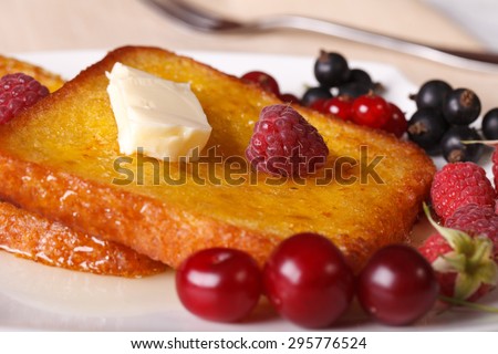 French toast with honey and fresh berries macro on a plate. horizontal