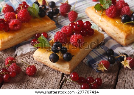Delicious cakes with berries, honey and mint on a table close-up. horizontal