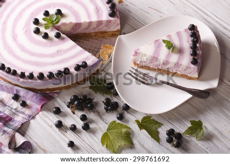 Beautiful cheese cake with currants close-up on the table. horizontal view from above