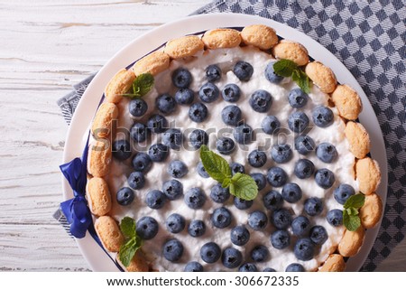 French blueberry cake charlotte with Savoiardi close-up on a plate. horizontal top view