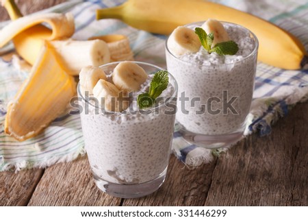 Healthy breakfast: chia seed pudding with banana in a glass close-up on the table. horizontal