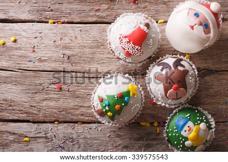 Christmas sweets: cupcakes closeup on a wooden table. horizontal top view