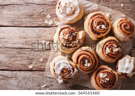 Cinnamon rolls with almond on the table. horizontal top view