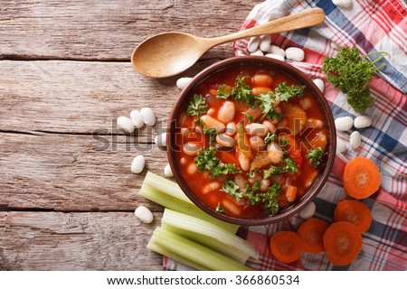 Homemade bean soup with ingredients. horizontal view from above